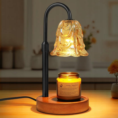 The Glow Candle Warmer Lamp on a wooden base with warm ambient light