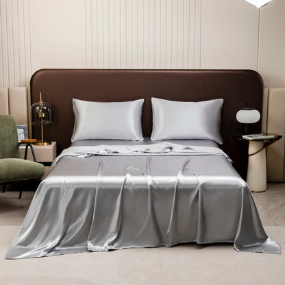 The Silk Touch Sheet Set in silver on a bed