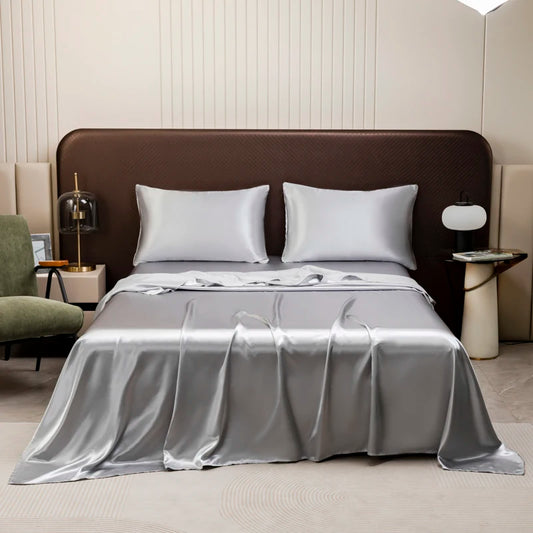 The Silk Touch Sheet Set in silver on a bed