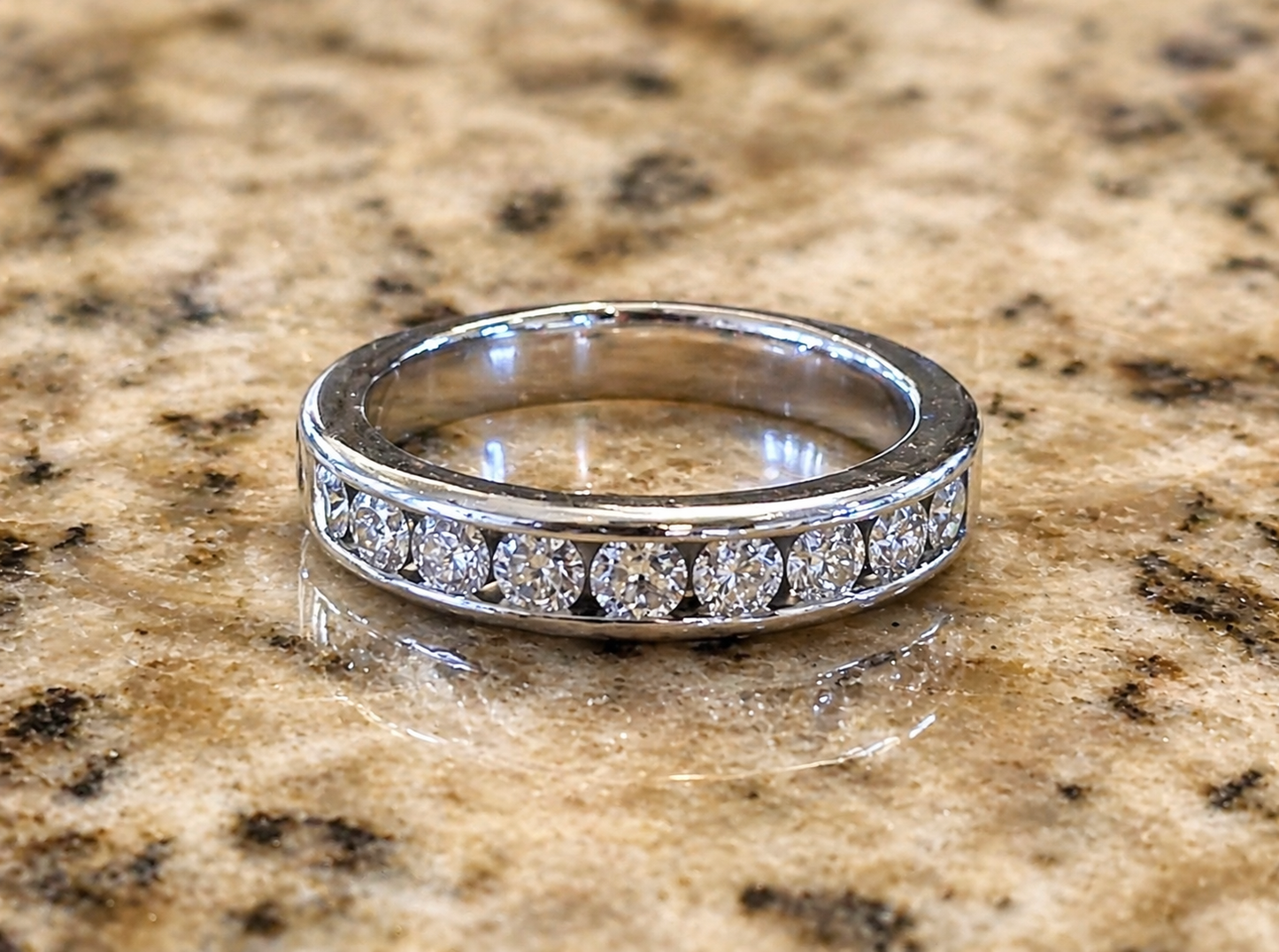 single 14K white gold diamond channel band front view showing full setting