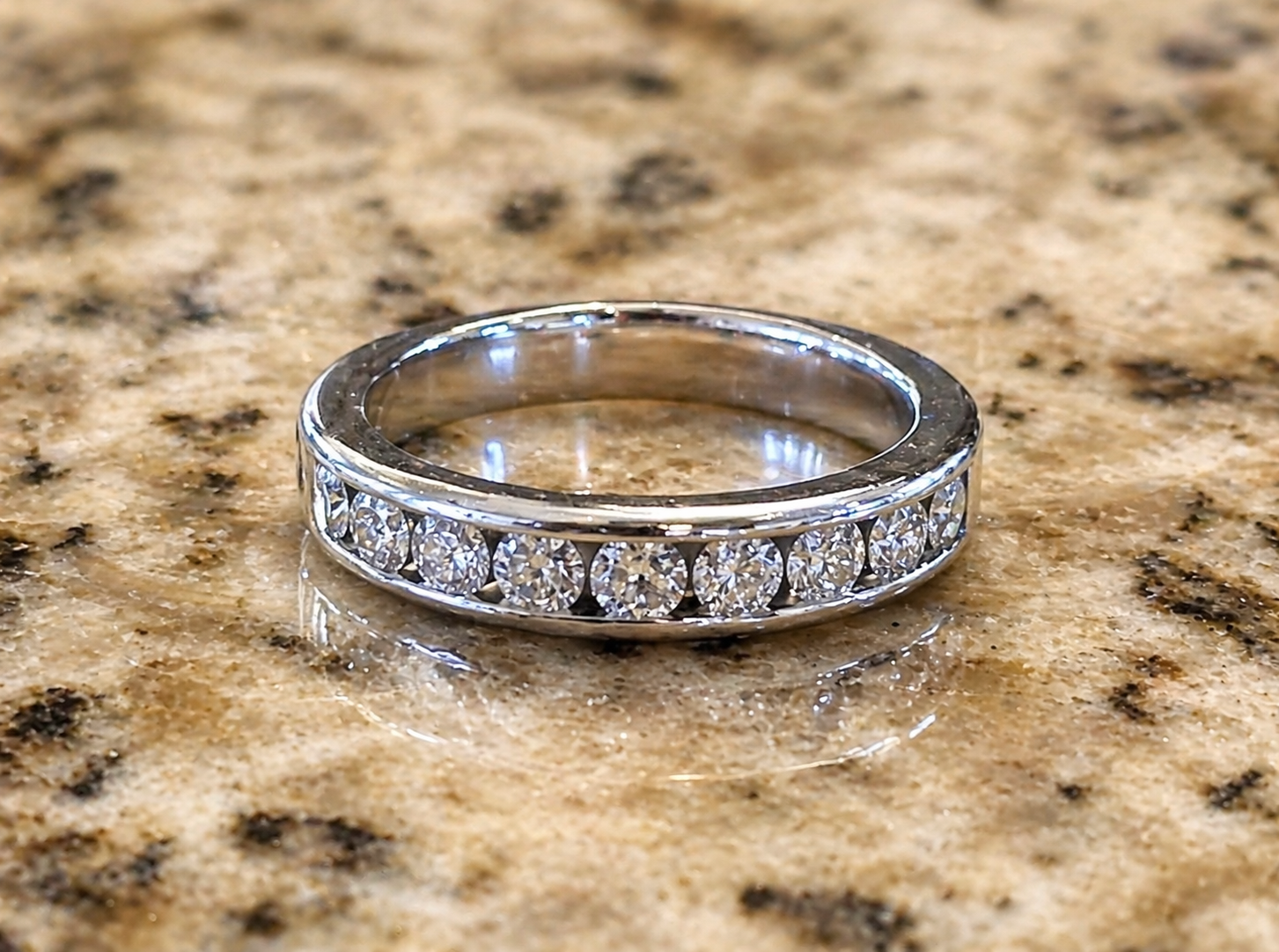 single 14K white gold diamond channel band front view showing full setting